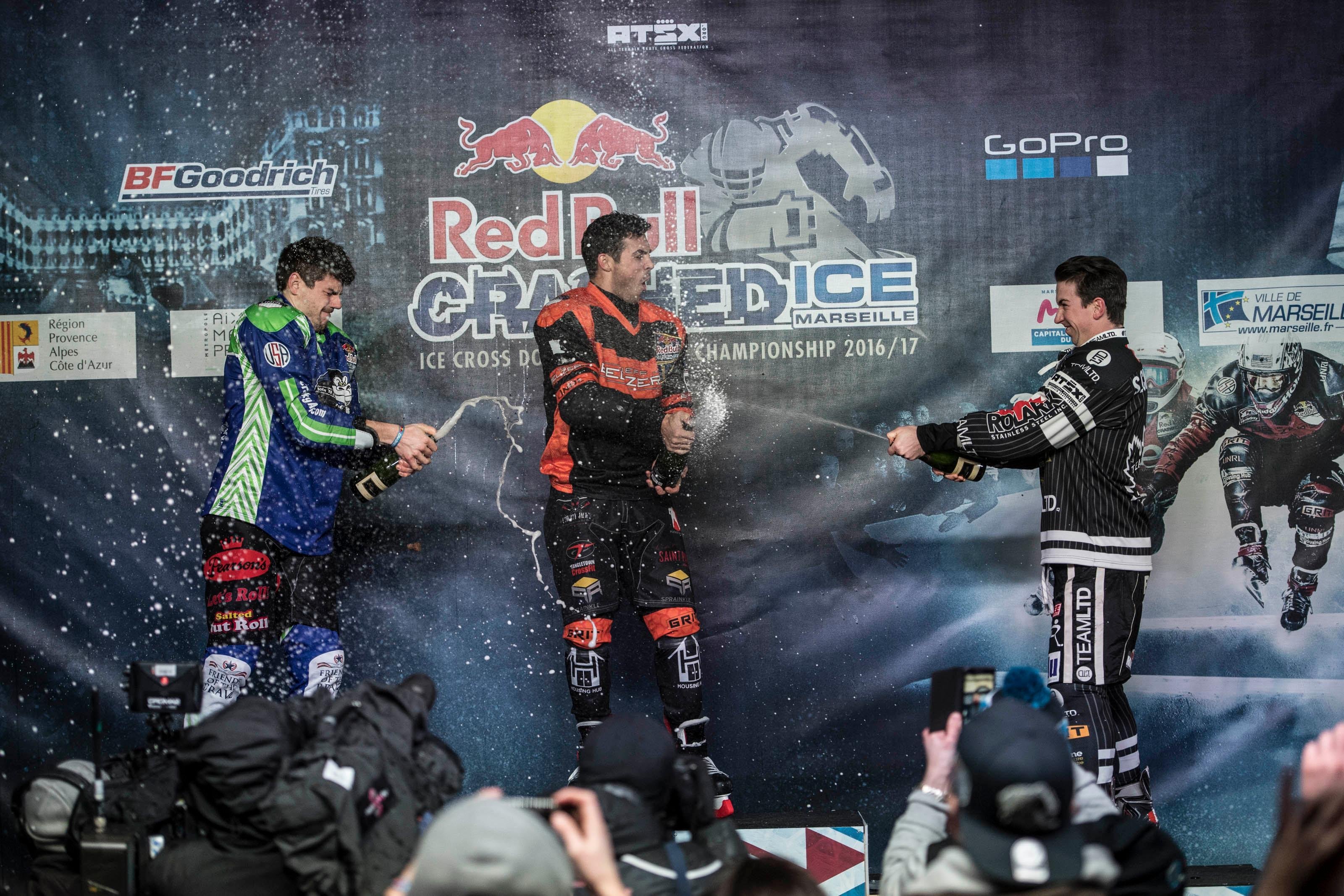 Cameron Naasz of the United States (C) celebrates with Maxwell Dunne of the United States (L) and Scott Croxall of Canada (R) during the Award Ceremony at the first stage of the ATSX Ice Cross Downhill World Championship at the Red Bull Crashed Ice in Marseille, France on January 14, 2017.